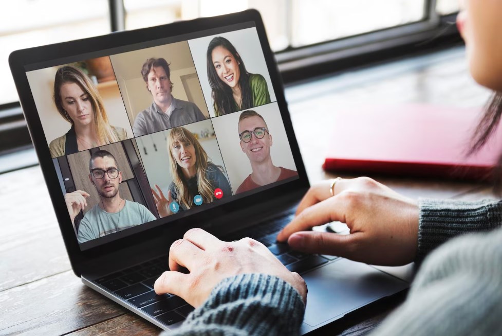 a group of people having an online video conference on Skype
