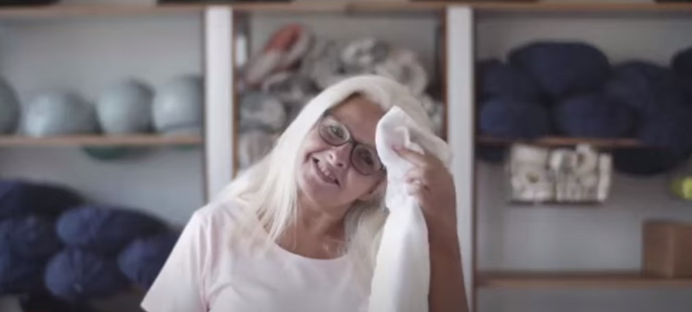 Woman wipes sweaty forehead with towel