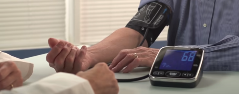 the hand of a man whose blood pressure is being checked