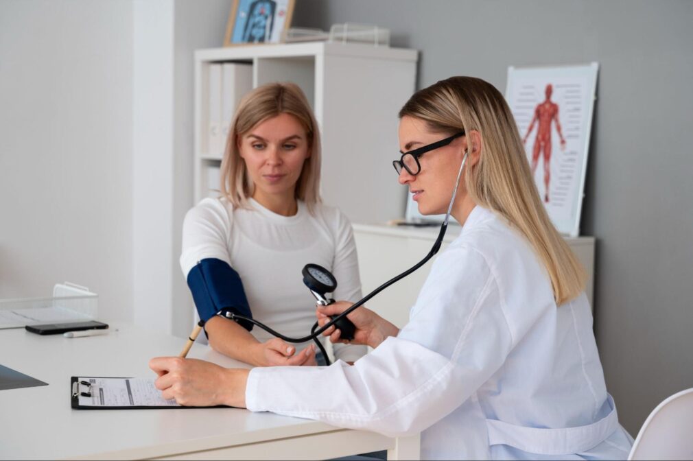 A female doctor measuring the patient’s blood pressure