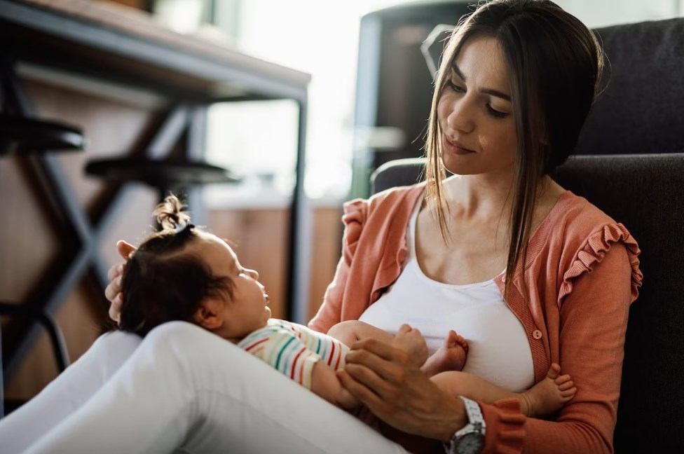 a loving mother enjoying spending time with her baby daughter at home