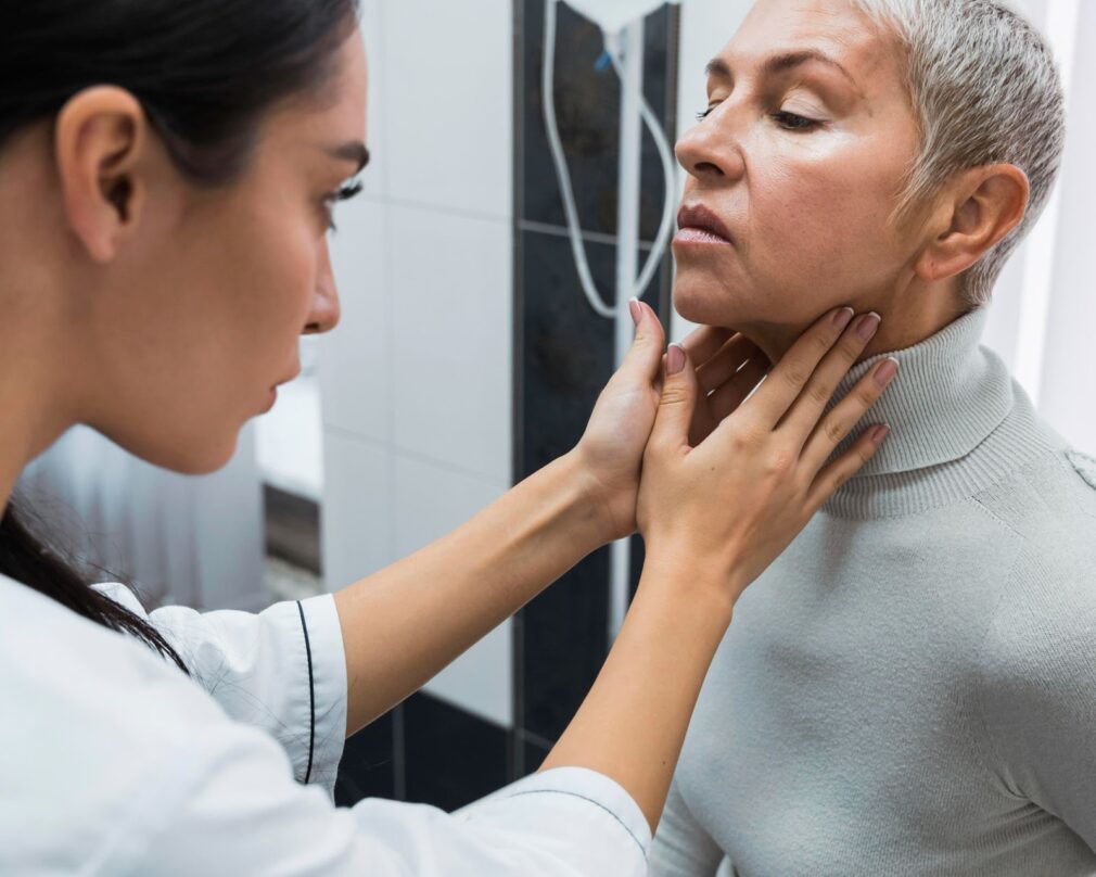 Doctor checking a patient's neck